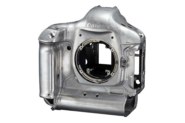 A silver, hollow camera body made of lightweight, high-strength magnesium alloy AZ31.