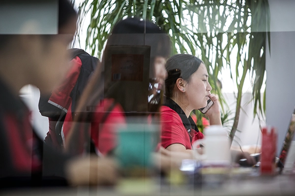 Office workers in a manufacturing company, reflecting the impact of labor costs and skill levels on production quality